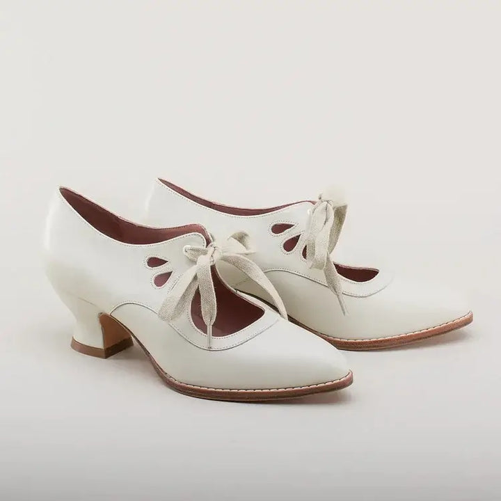 Chic pin-up inspired heels on a plain background.
