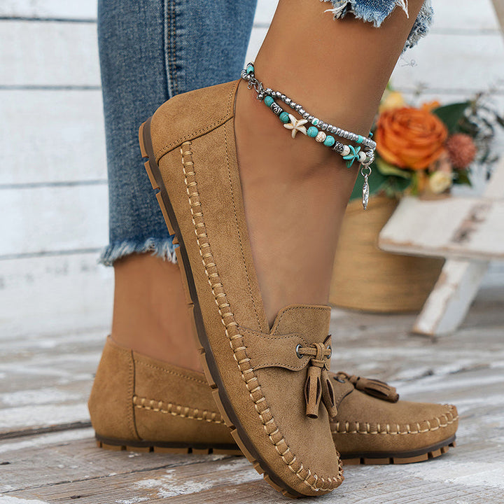 Women’s everyday loafers with vintage charm on a plain background.