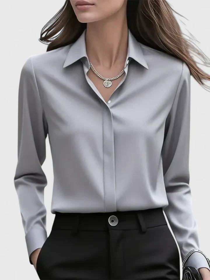 Female in a long sleeve button-down shirt styled against a plain background.
