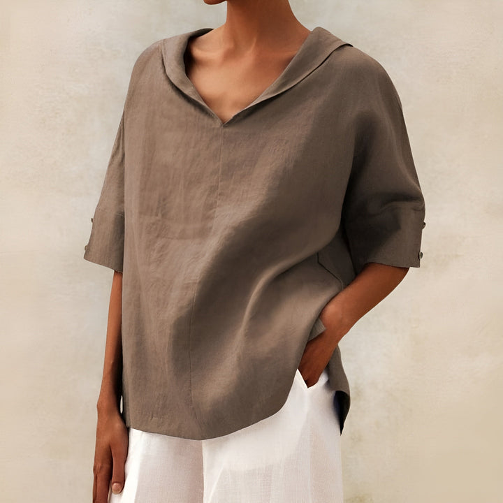  Female modelling a loose-fitting blouse with an airy appearance.