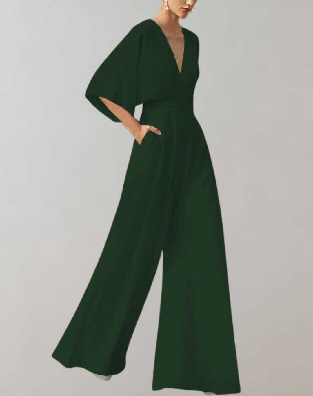 Model wearing a feminine wide leg one piece with graceful sleeve
