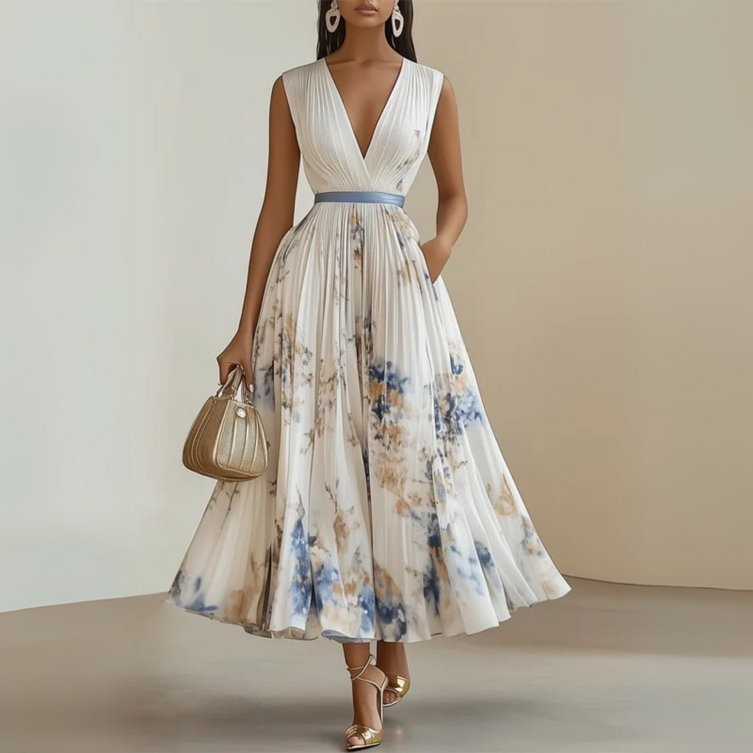 Female modelling a printed maxi dress with a deep V-neck and flowing pleats.