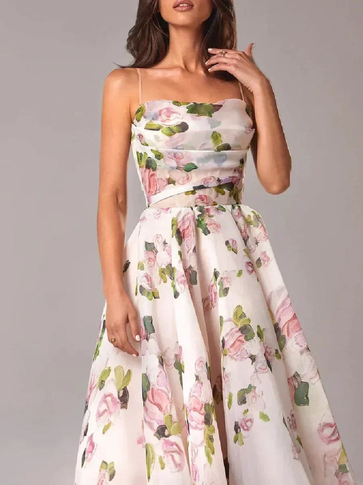 Woman displaying a midi dress with a delicate floral pattern and graceful movement on a plain background.