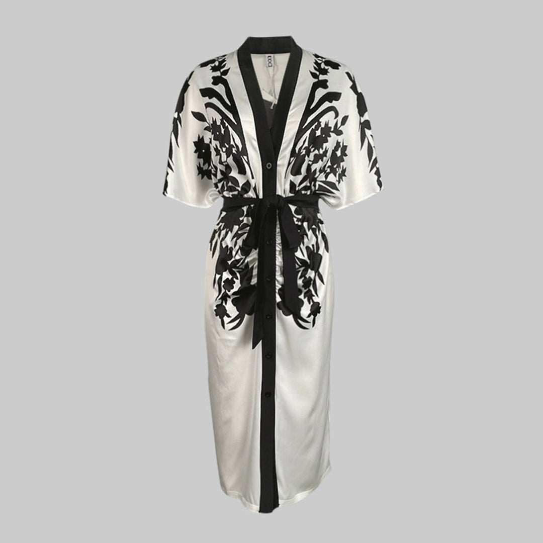 Button-front floral midi dress with a waist tie on a plain background.