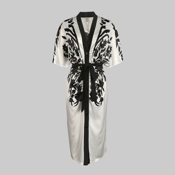 Button-front floral midi dress with a waist tie on a plain background.