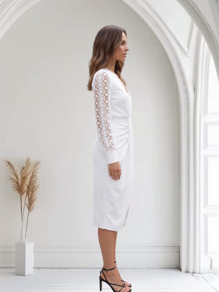Female model wearing a twist-front midi dress with lace sleeves.