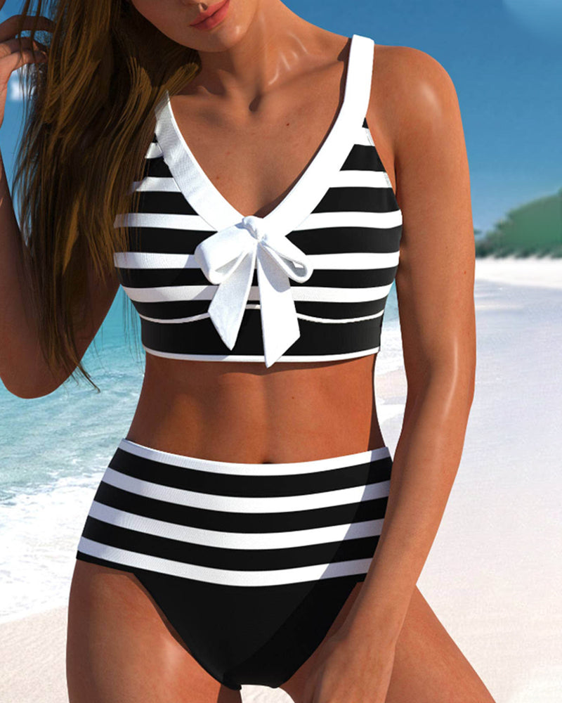 Female model wearing a boho print tankini swimsuit on a plain background.