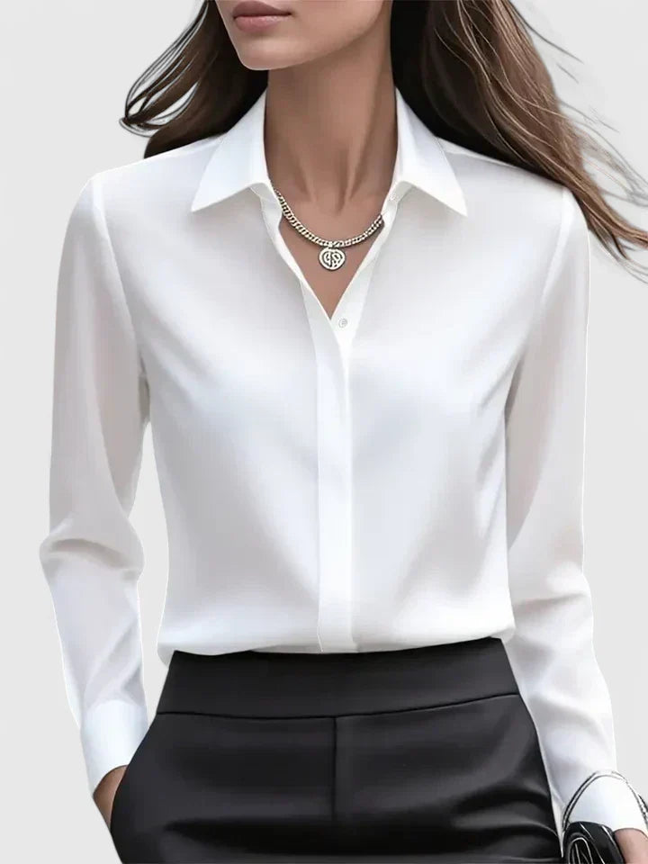  Female modelling a long sleeve shirt with a concealed button front on a plain background.