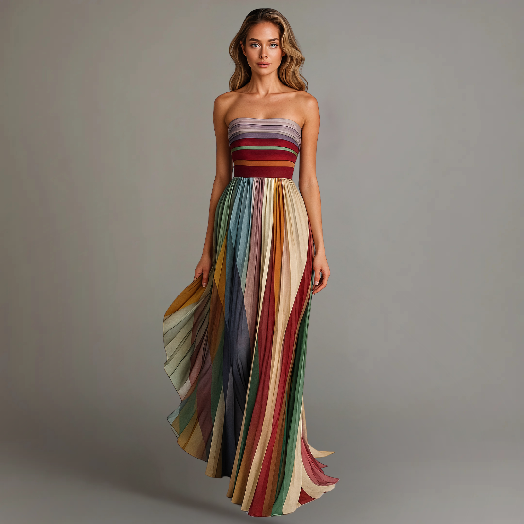 Woman wearing a strapless full-length dress with a panelled skirt against a plain background.