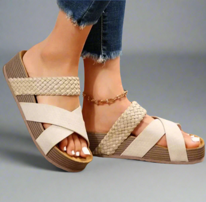 Woman modelling comfortable sandals with adjustable fit and airy design.