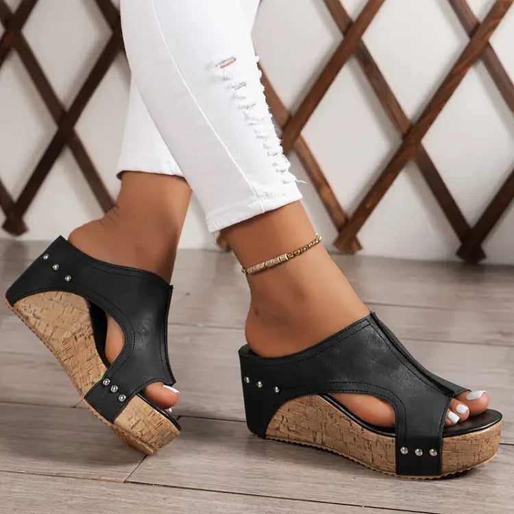 Female model wearing open-toe sandals with supportive footbed on a plain background.