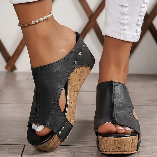 Woman showcasing lightweight comfort sandals on a plain background.