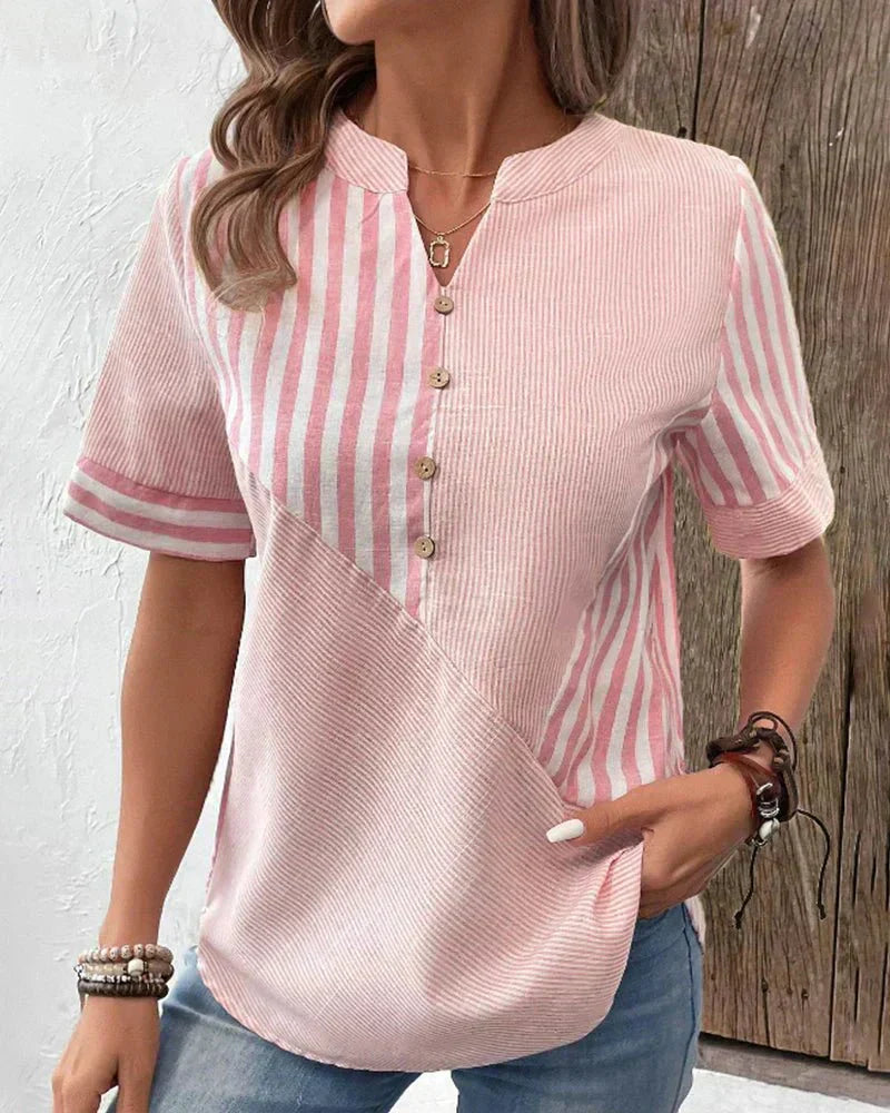  Female modelling a lightweight striped blouse with a flowing silhouette.