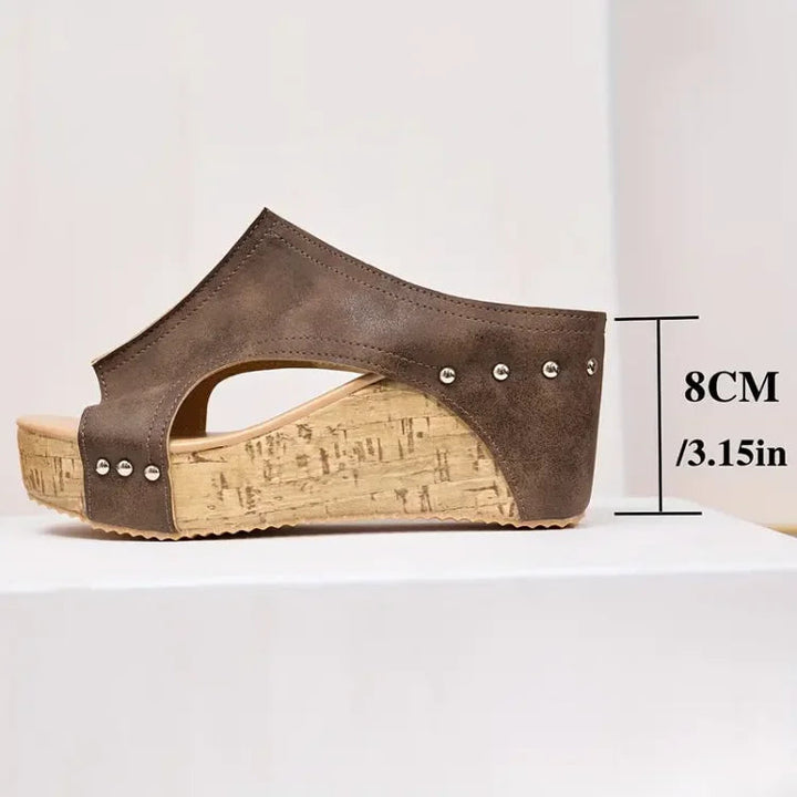 Adjustable strap sandals on a plain background.
