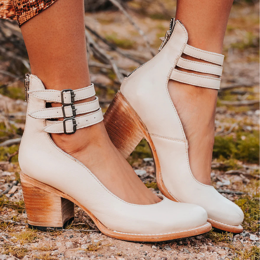 Female wearing elegant open-toe sandals with refined detailing.