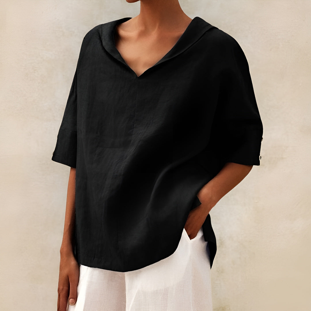  Female in a flowing blouse paired with a relaxed silhouette.
