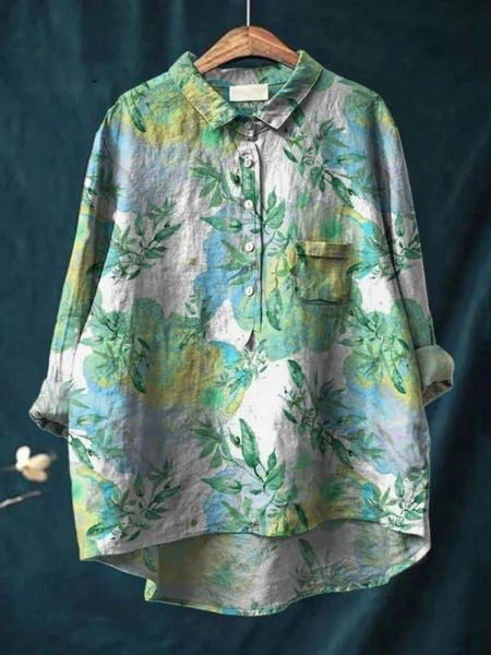 An elegant floral blouse styled against a plain background.