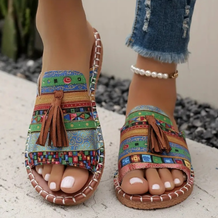Female model wearing casual warm-weather sandals on a plain background.