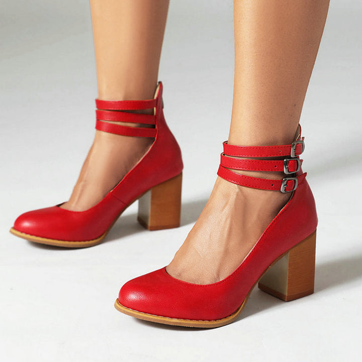 Female wearing modern strap sandals with a polished look on a plain background.