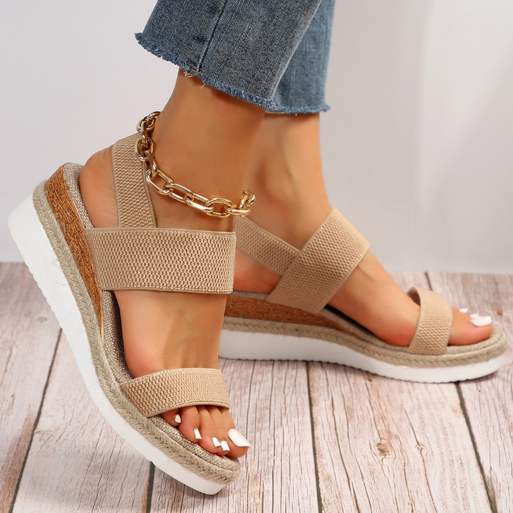 Female model wearing cushioned open-toe sandals on a plain background for everyday casual styling.