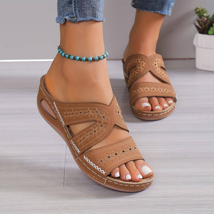 Woman in airy walking sandals with wide supportive straps.