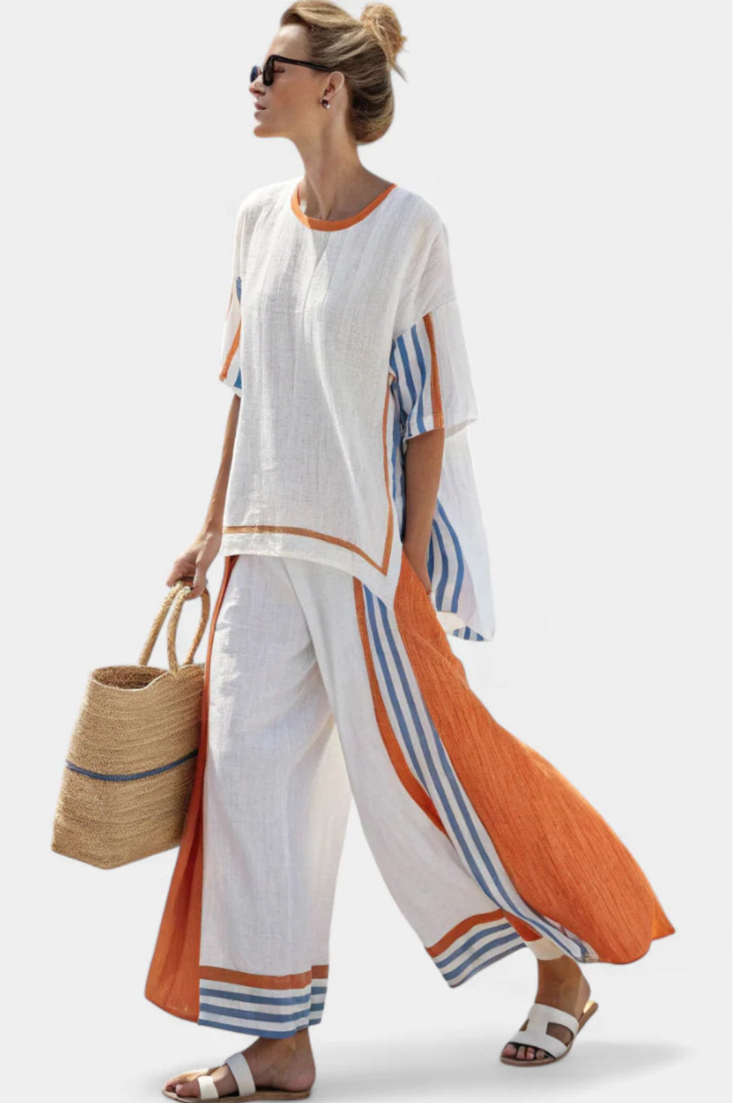Female model wearing a relaxed two piece set against a plain background.