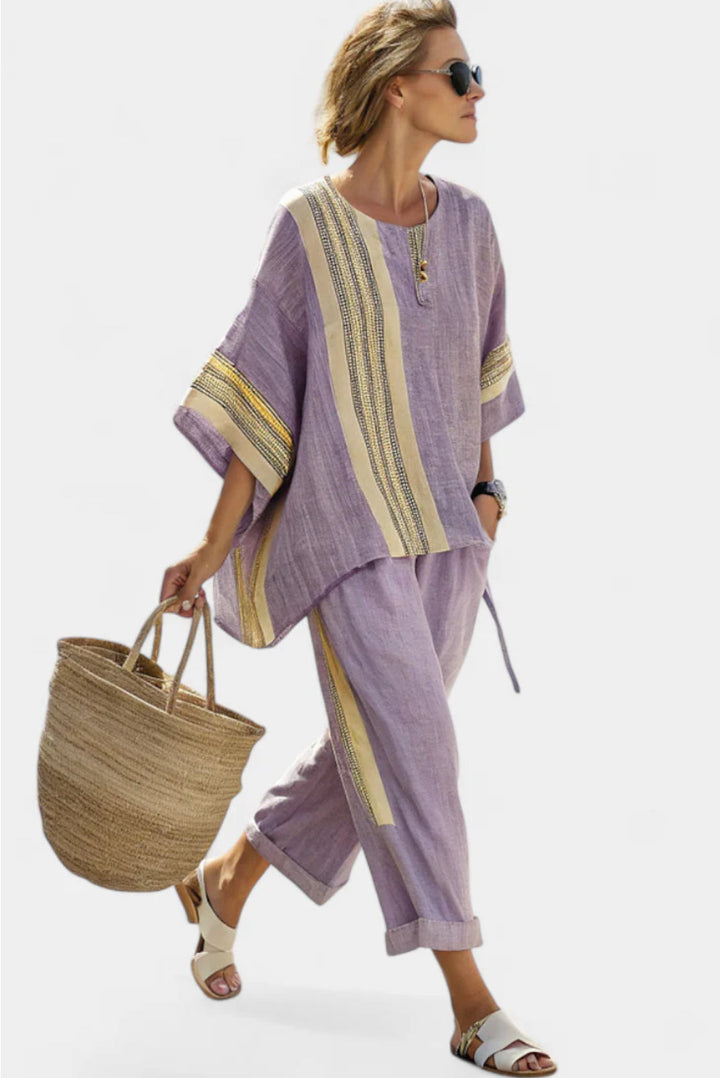Female model in a coordinated warm weather outfit on a plain background.