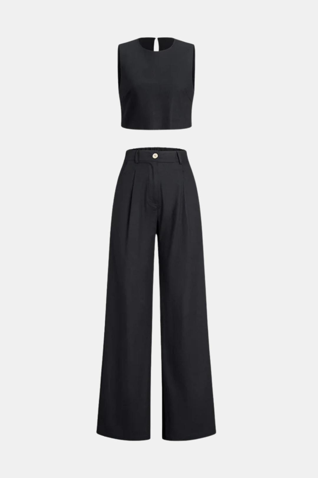 Woman in a boho two-piece pants outfit with a cropped top on a plain background.