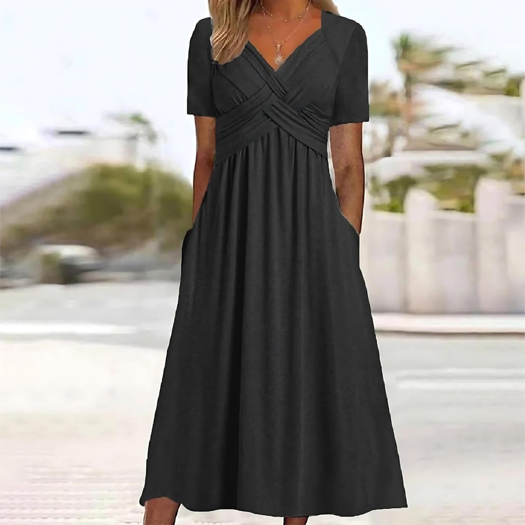 Woman in a V-neck midi dress shown on a plain background.