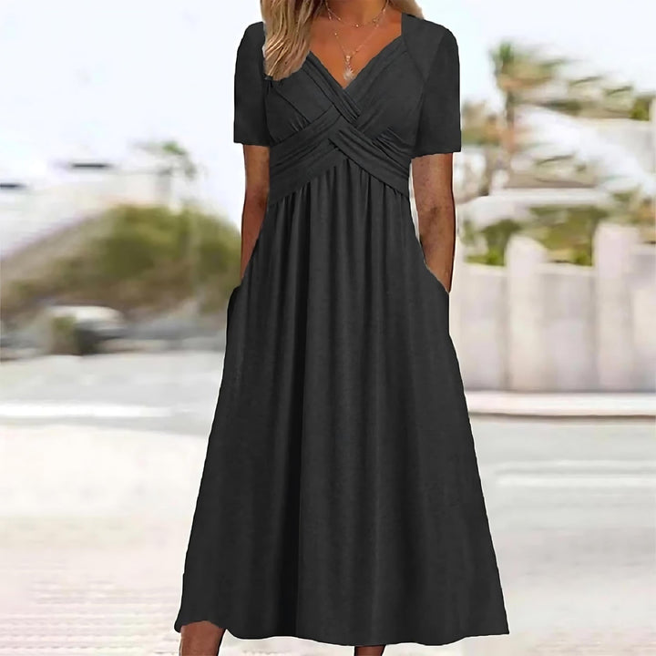 Woman in a V-neck midi dress shown on a plain background.