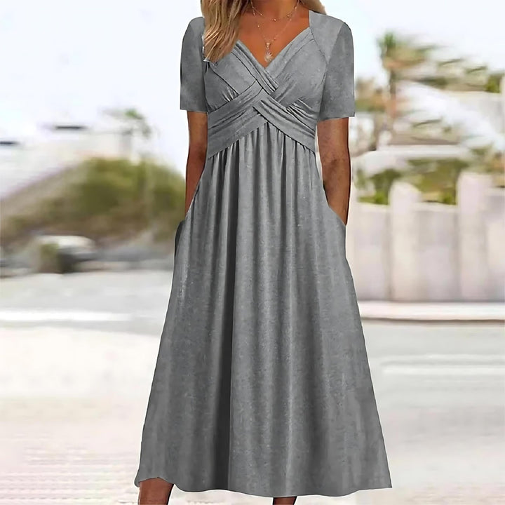 Model wearing a relaxed fit midi dress against a plain background.
