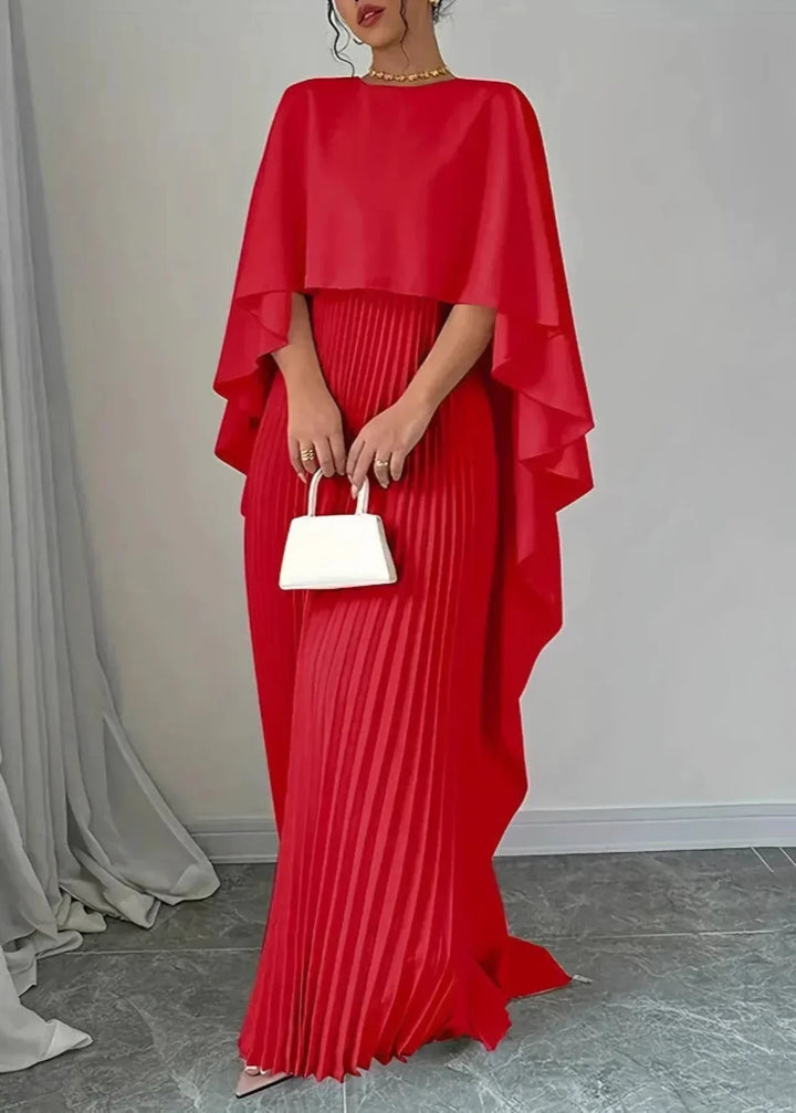 Model wearing an elegant pleated dress for special gatherings on a plain background.