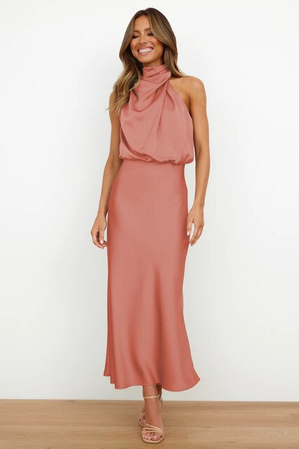 Female showcasing an off-shoulder formal dress on a plain background.