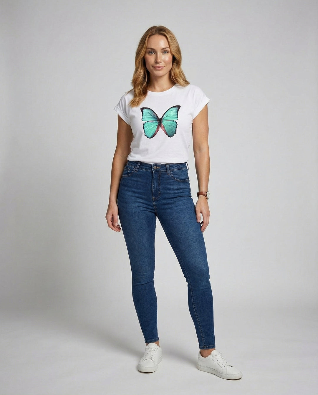 Female modelling a relaxed fit short sleeve T-shirt on a plain background.