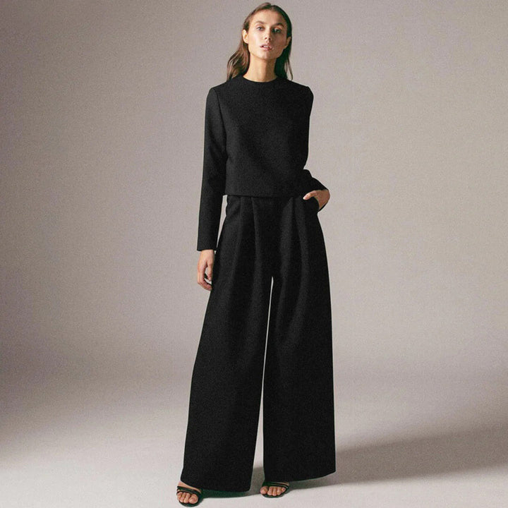 Woman in a casual matching two-piece set with relaxed wide-leg trousers.