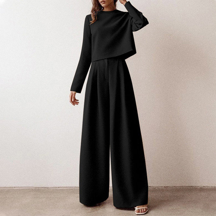 Female modelling a fitted long-sleeved top with cropped wide-leg trousers.