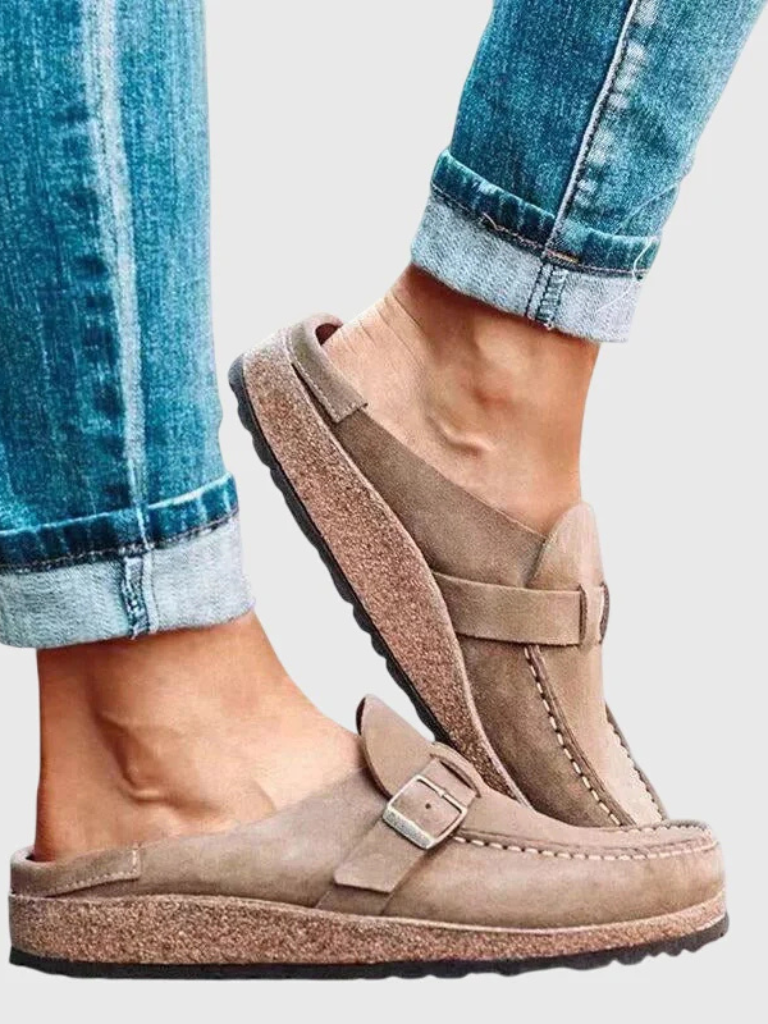 Woman modelling lightweight clogs for daily indoor and outdoor wear on a plain background.