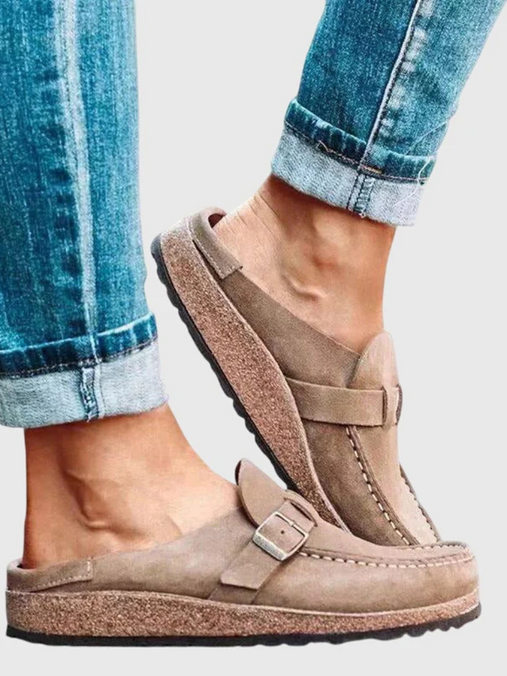 Woman modelling lightweight clogs for daily indoor and outdoor wear on a plain background.