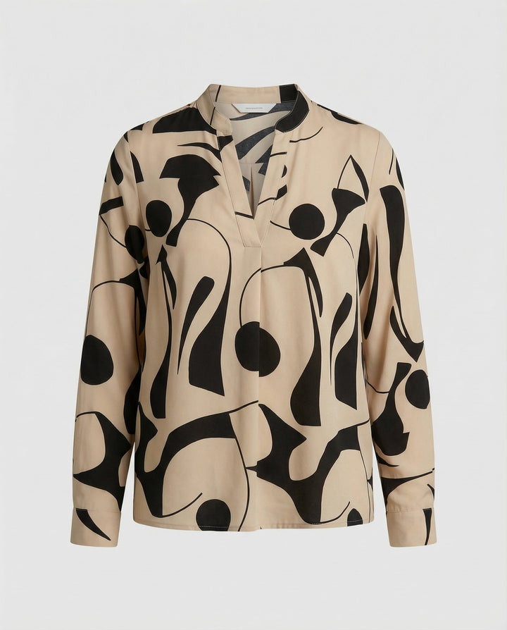Versatile blouse paired with casual styling on a plain background.