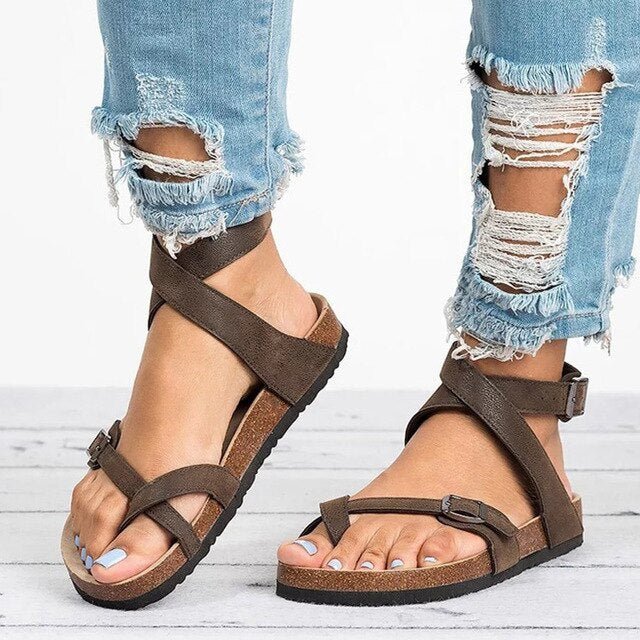 Woman wearing adjustable comfort sandals on a plain background for casual summer styling.