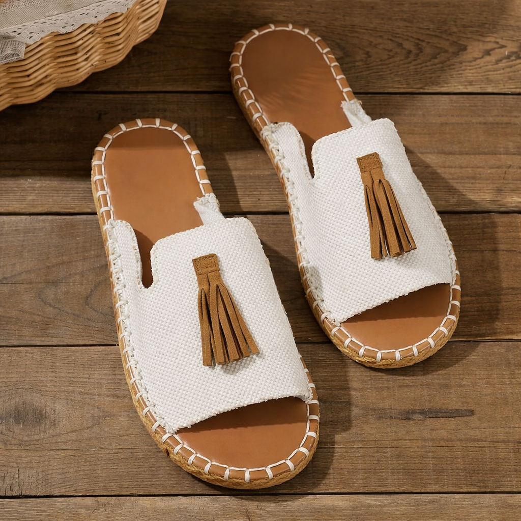 Woman wearing lightweight slip-on sandals on a clean plain background.