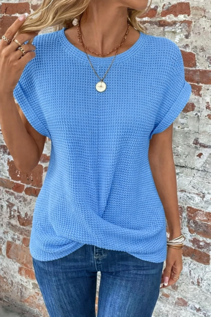  Woman modelling a casual short sleeve top with subtle textured detail.