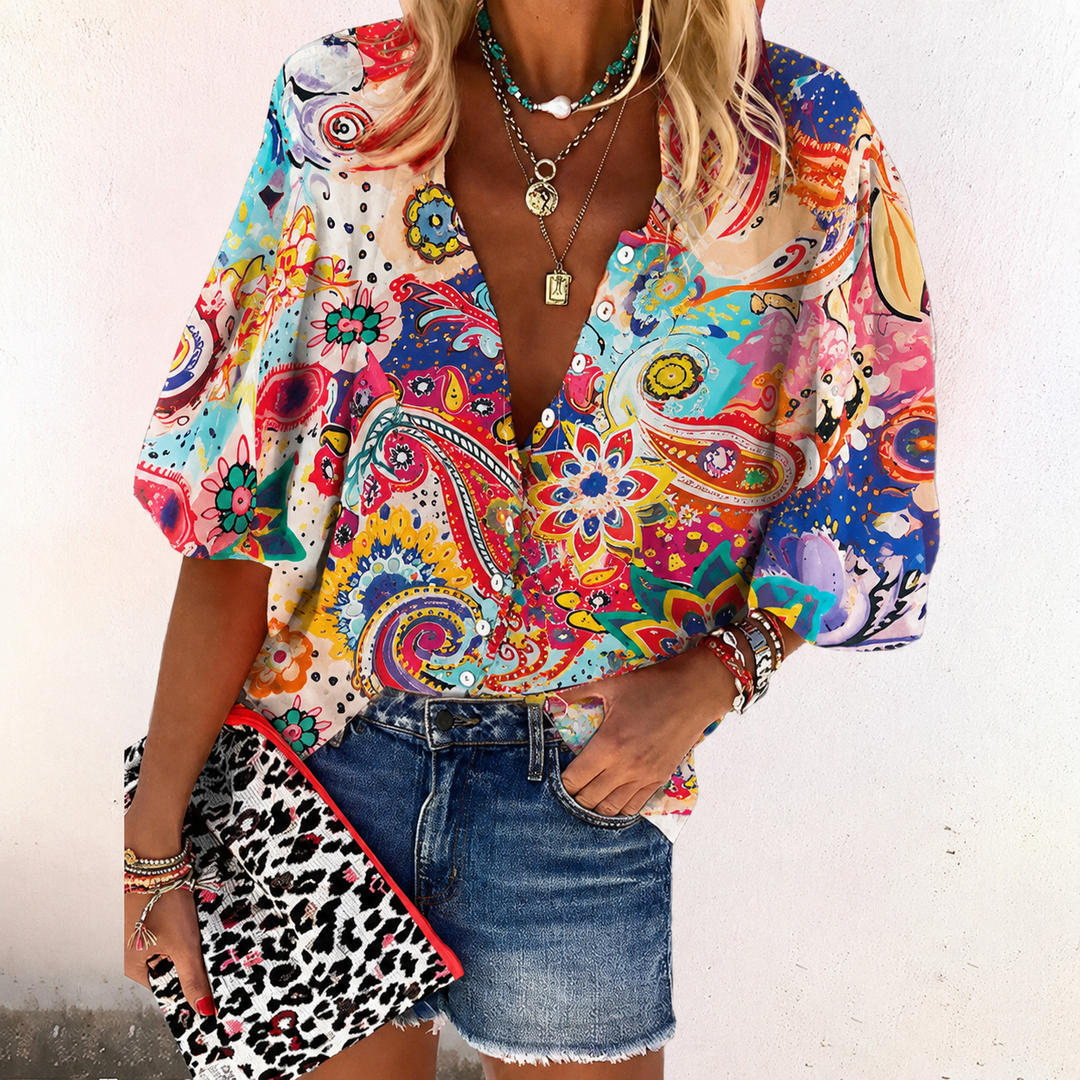  Female modelling a boho-inspired blouse with an all-over decorative print.