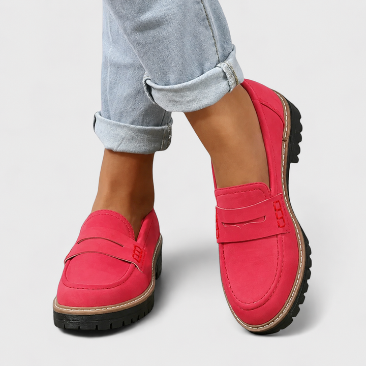 Female loafers displayed on a plain background with a smooth slip-on style.