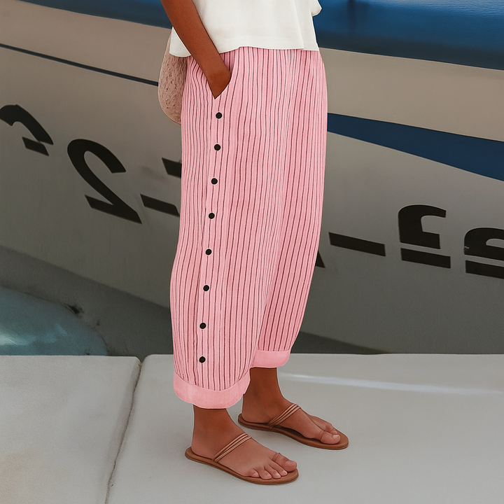 Female wearing striped trousers with a comfortable straight-leg silhouette.