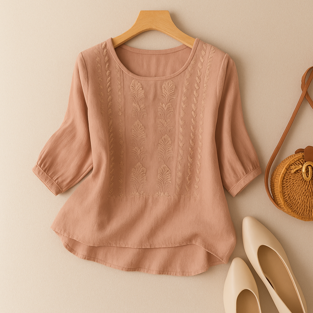 Short sleeve embroidered blouse shown against a plain studio background.