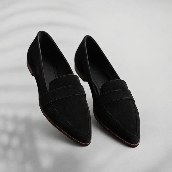 Sleek toe loafers against a plain background.