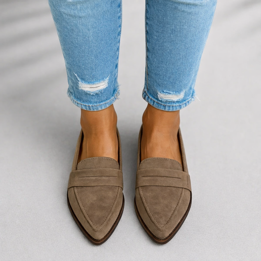 Female model displaying refined toe loafers on a plain background.