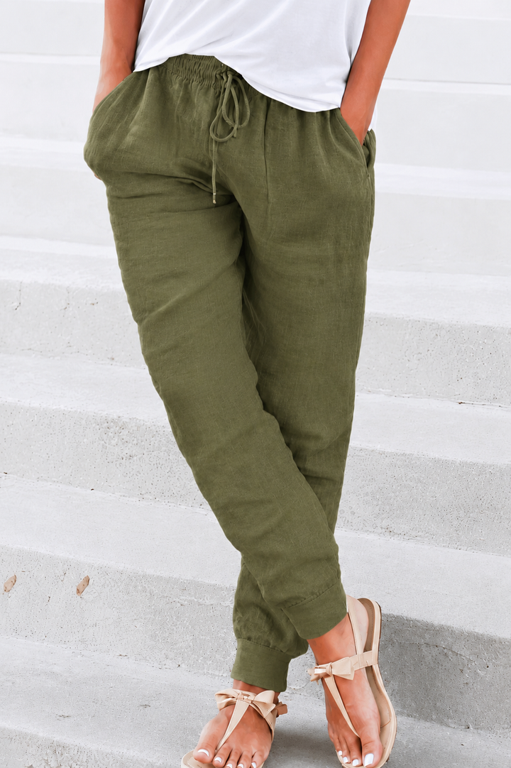 Female model in lightweight casual trousers with gathered ankle cuffs. 