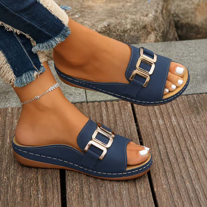 Female model displaying adjustable strap sandals on a plain background.